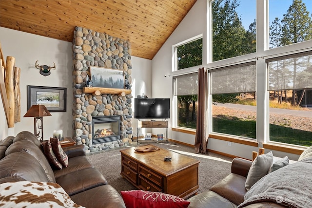 carpeted living room with a healthy amount of sunlight, a fireplace, and high vaulted ceiling