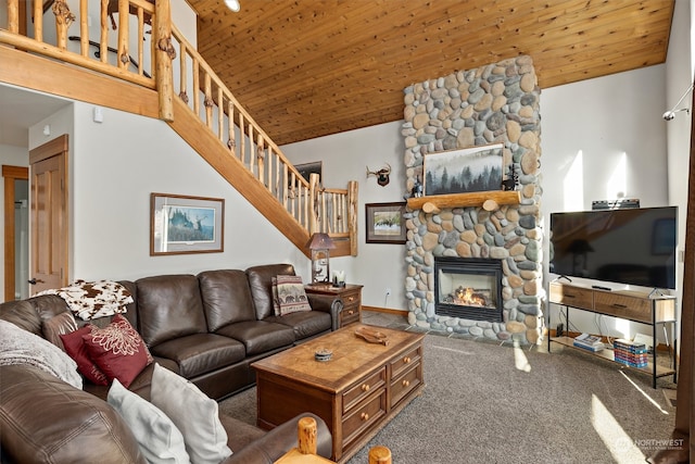 carpeted living room with wooden ceiling, a high ceiling, and a fireplace