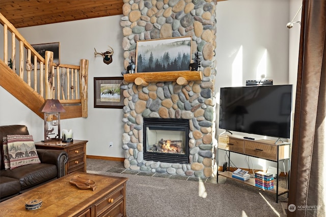 carpeted living room with wood ceiling, vaulted ceiling, and a stone fireplace