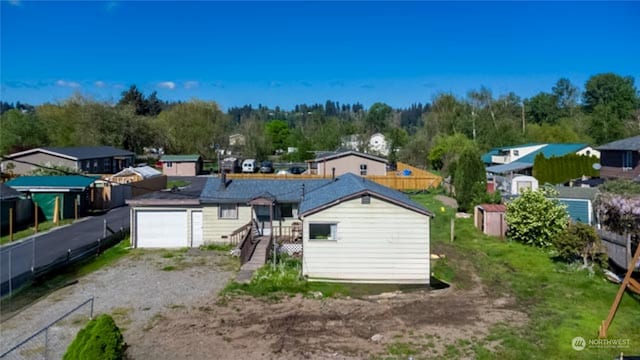 exterior space with a garage and a storage unit