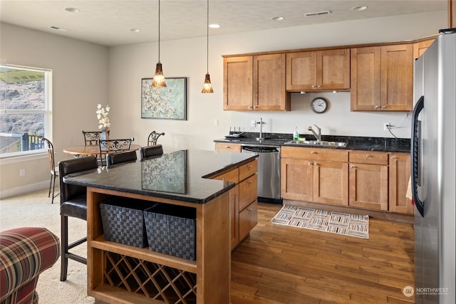 9246 Red Cliff Dr NW Unit B66, Quincy, WA 98848 - kitchen featuring appliances with stainless steel finishes, hardwood / wood-style flooring, sink, pendant lighting, and a center island