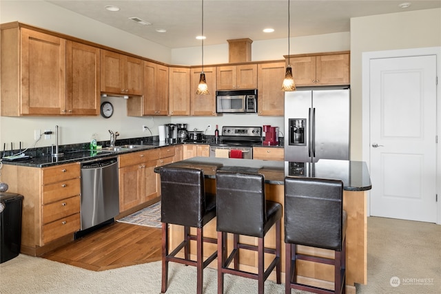 9246 Red Cliff Dr NW Unit B66, Quincy, WA 98848 - kitchen with a center island, hanging light fixtures, hardwood / wood-style floors, appliances with stainless steel finishes, and sink