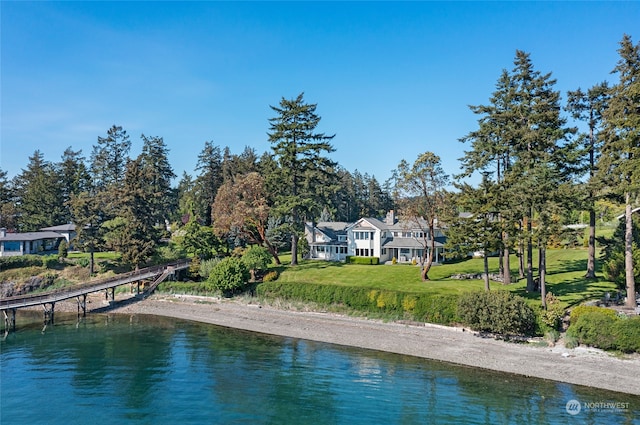 view of pool featuring a lawn and a water view