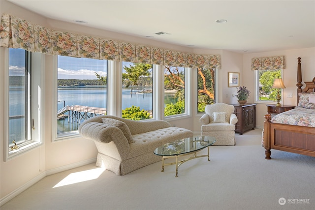 bedroom with a water view and carpet