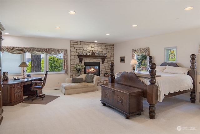 bedroom with carpet and a fireplace