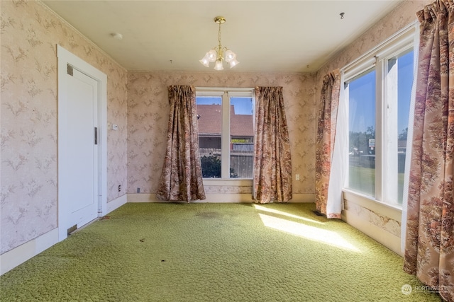 carpeted empty room with a notable chandelier