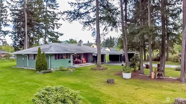 rear view of house featuring a yard