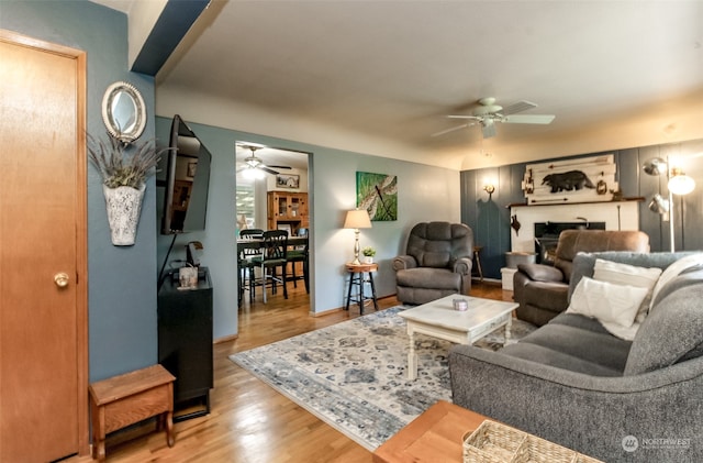 living room with wood-type flooring and ceiling fan