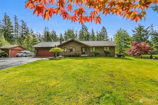 single story home with a front yard and a garage