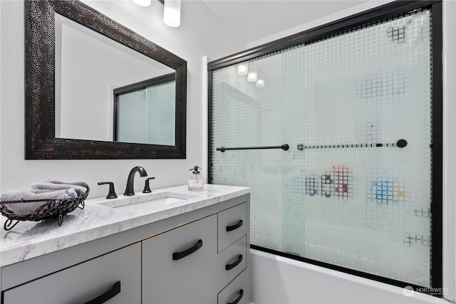 bathroom with shower / bath combination with glass door and vanity