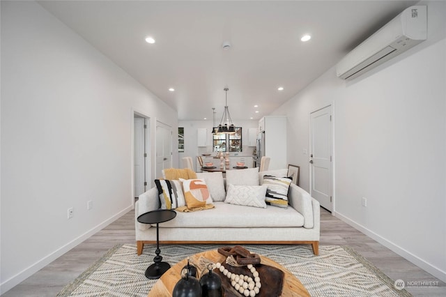 living room featuring light wood-type flooring and a wall mounted AC