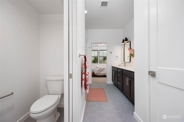 bathroom featuring toilet and vanity