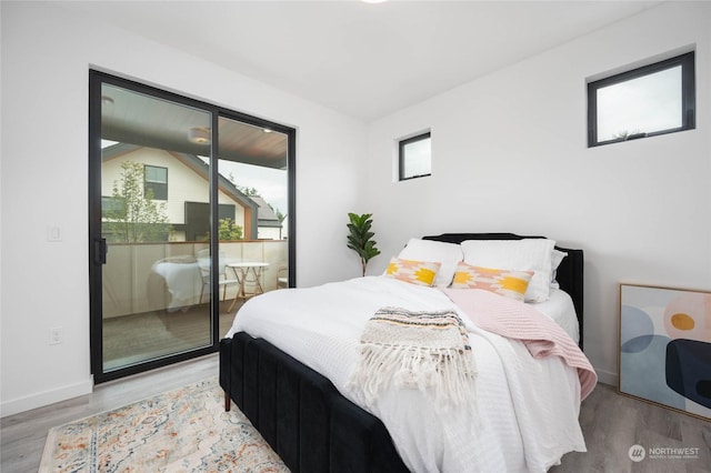 bedroom with light hardwood / wood-style floors and access to outside