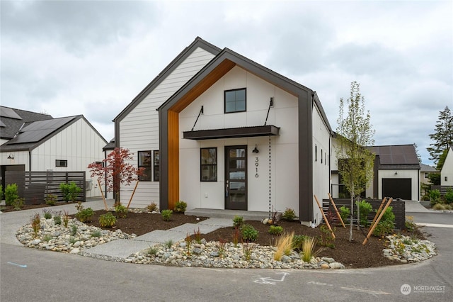 view of front facade featuring a garage and solar panels