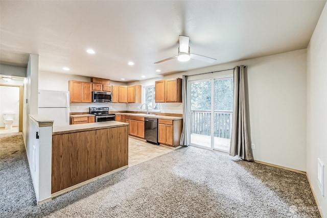 kitchen with appliances with stainless steel finishes, ceiling fan, sink, and light tile flooring