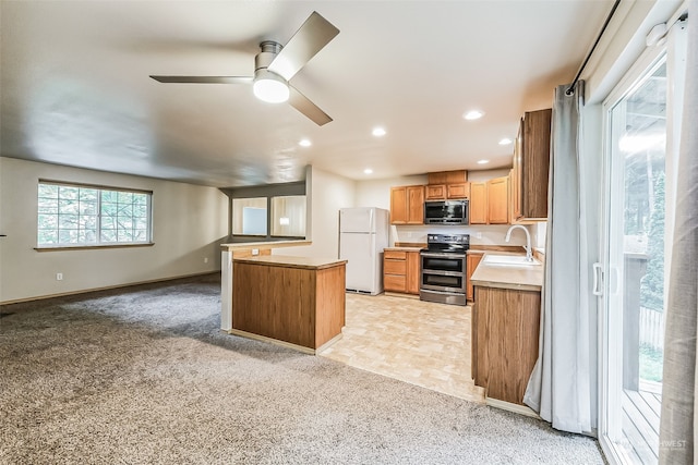 kitchen with appliances with stainless steel finishes, a center island, ceiling fan, light tile floors, and sink