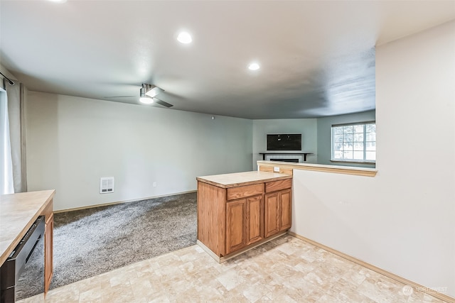 kitchen with light carpet, ceiling fan, kitchen peninsula, and stainless steel dishwasher