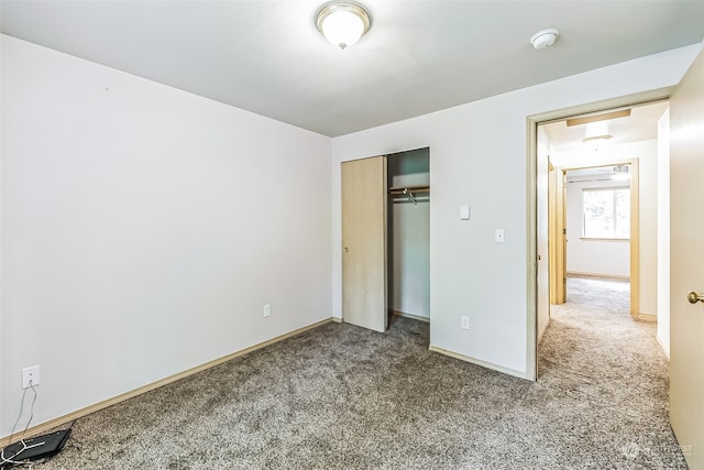 unfurnished bedroom with a closet and carpet floors