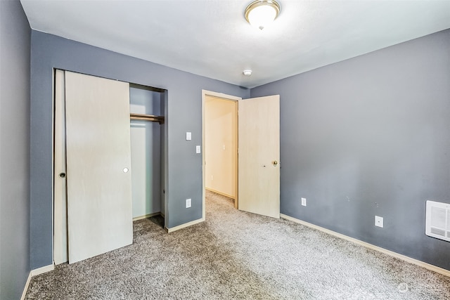 unfurnished bedroom featuring a closet and carpet