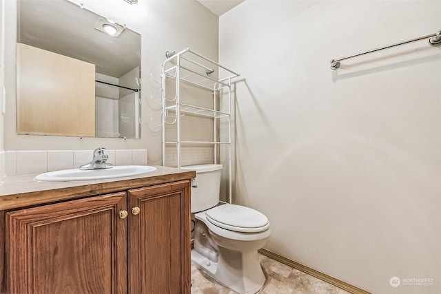 bathroom with tile flooring, vanity, and toilet