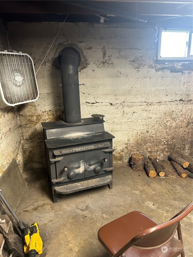 details with a wood stove and concrete floors