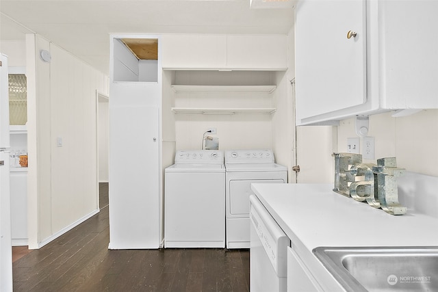 clothes washing area featuring dark hardwood / wood-style flooring, washing machine and dryer, and sink