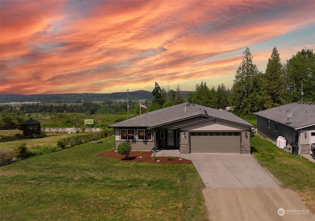 view of front of house with a garage and a lawn