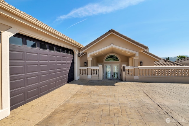 view of front facade featuring french doors and a garage