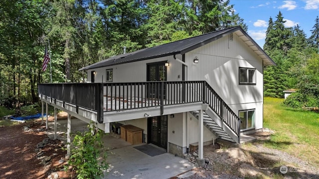 rear view of house with a wooden deck