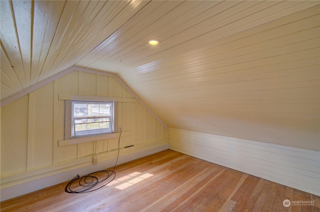 bonus room featuring vaulted ceiling and light wood-type flooring