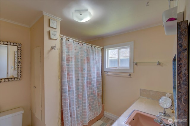 bathroom featuring walk in shower, ornamental molding, vanity, wood-type flooring, and toilet