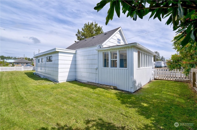 view of side of home with a lawn