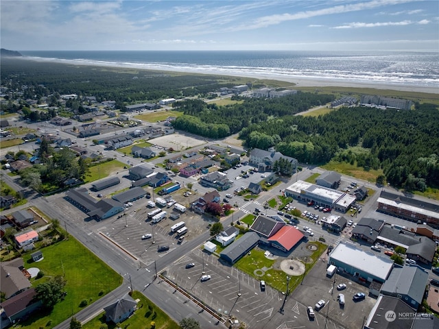 birds eye view of property featuring a water view and a beach view