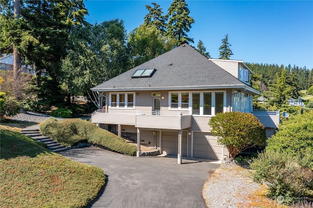 back of house featuring a garage