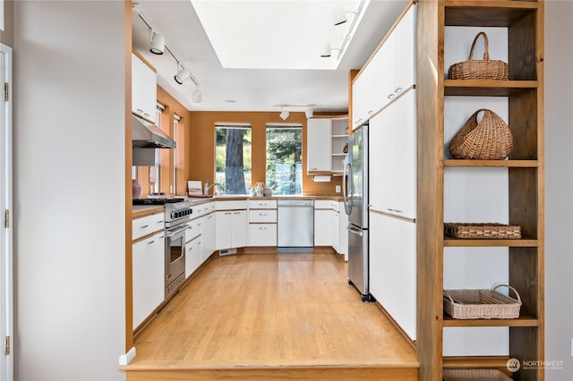 kitchen featuring light hardwood / wood-style flooring, white cabinets, and appliances with stainless steel finishes