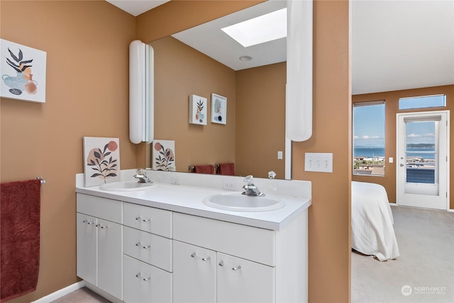 bathroom featuring vanity and a skylight