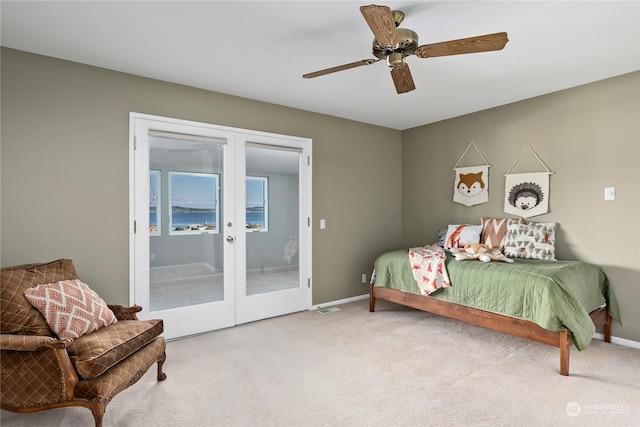 bedroom with light carpet, french doors, access to outside, and ceiling fan