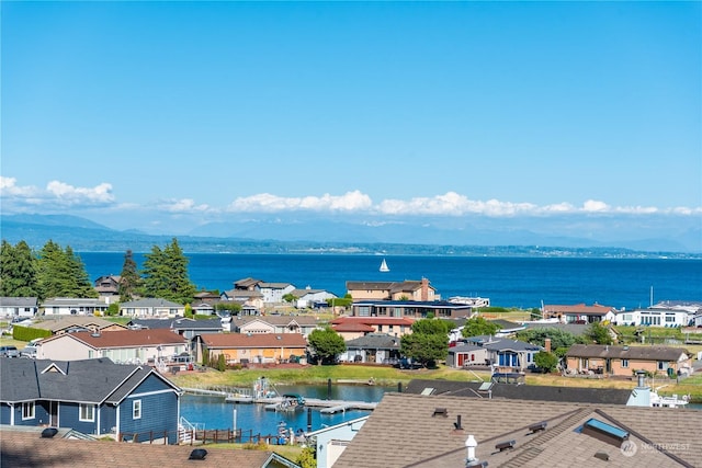 birds eye view of property with a water and mountain view