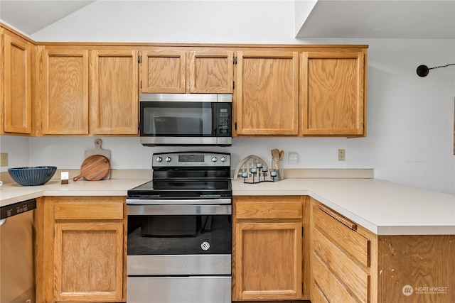 kitchen with light brown cabinets and appliances with stainless steel finishes