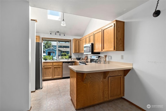 kitchen with pendant lighting, lofted ceiling with skylight, light tile patterned floors, kitchen peninsula, and stainless steel appliances