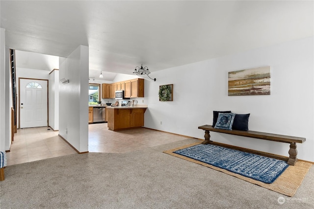 living room with a chandelier, light colored carpet, and lofted ceiling