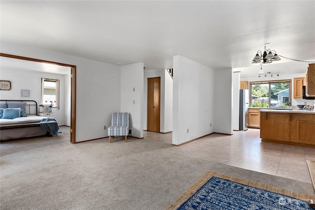 living room with light colored carpet, an inviting chandelier, and plenty of natural light