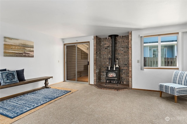 living room featuring a wood stove and carpet floors