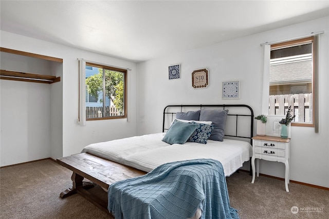 bedroom featuring dark carpet and a closet