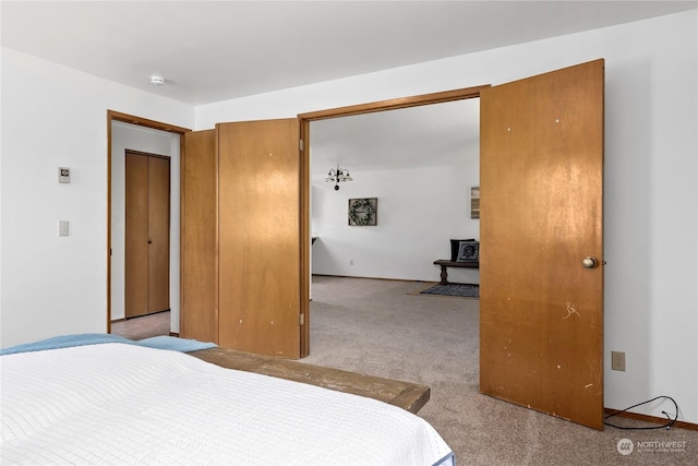 bedroom with light carpet and a closet