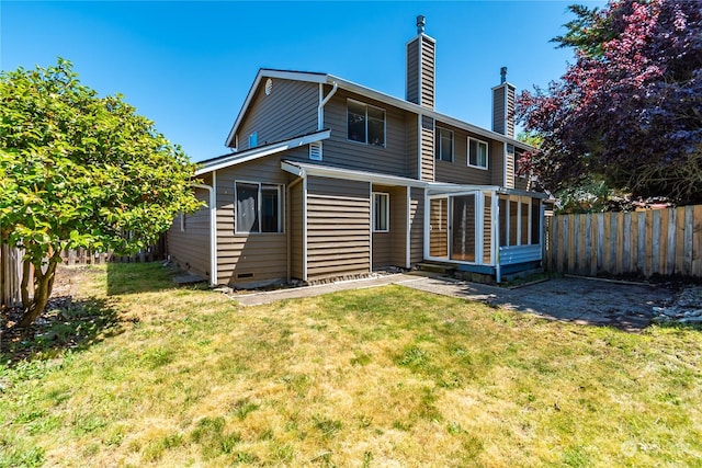 back of house featuring a lawn