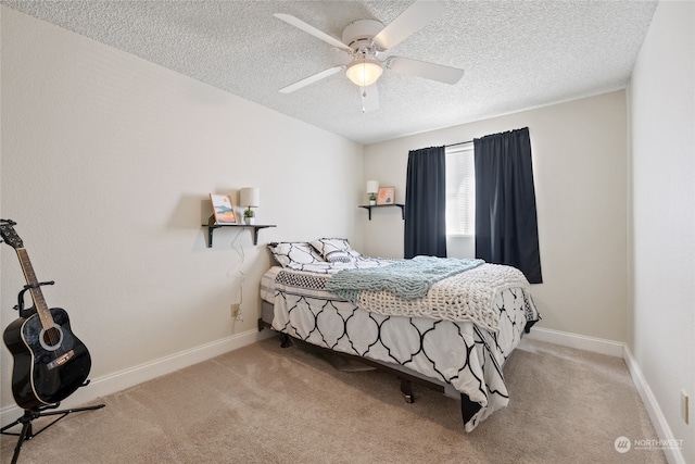 carpeted bedroom with ceiling fan and a textured ceiling