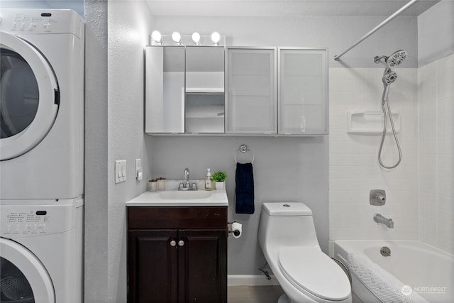 full bathroom with stacked washer and dryer, tiled shower / bath combo, toilet, and vanity