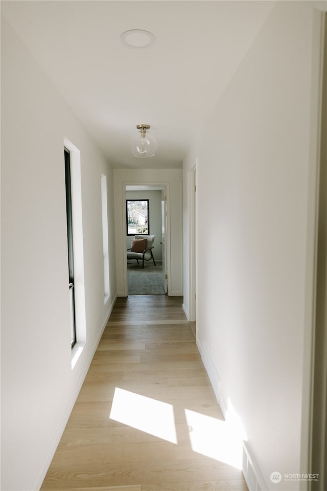 corridor featuring light hardwood / wood-style floors