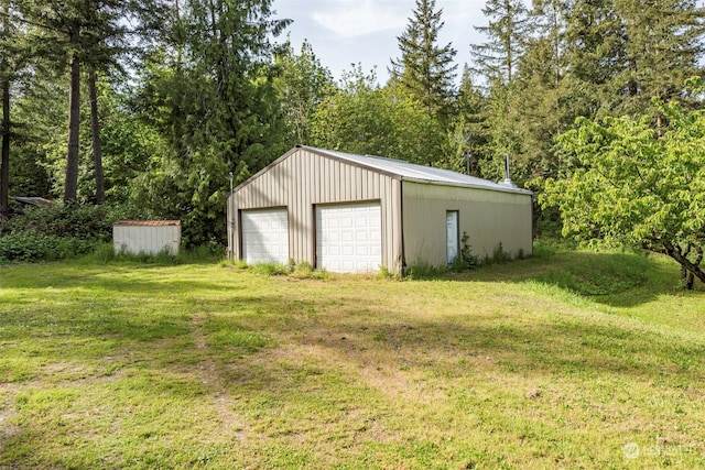 garage featuring a lawn